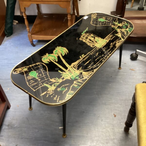 Vintage 1960s galleon coffee table with glass top and nautical scene.
