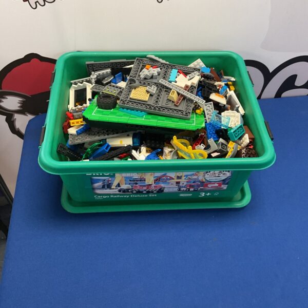 Assorted mixed Lego bricks in a plastic storage box.