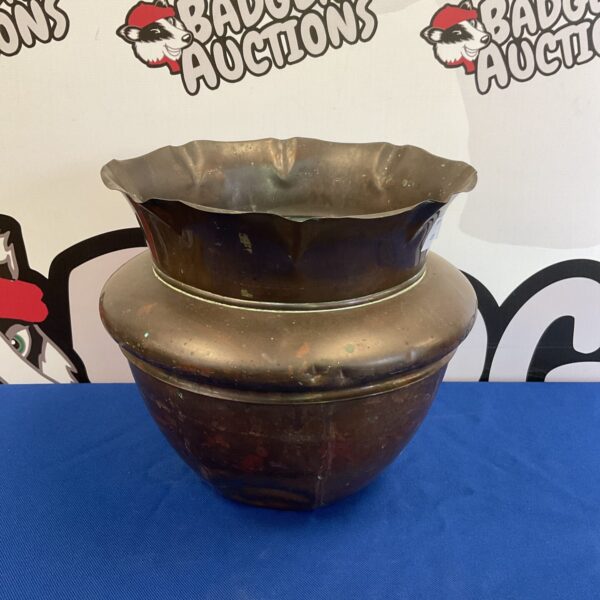 Vintage copper plant pot with patina, ideal for garden display.