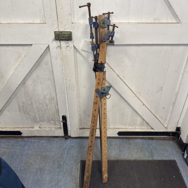 Vintage sash clamp bundle with wooden and metal construction.