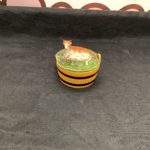 Vintage pottery butter dish with cow figurine for farmhouse decor.