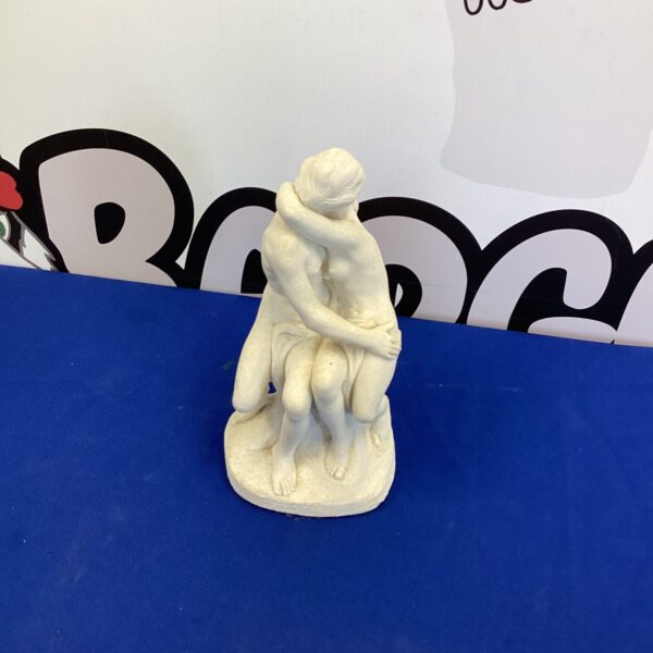 Vintage porcelain kissing couple figurine for romantic decor.