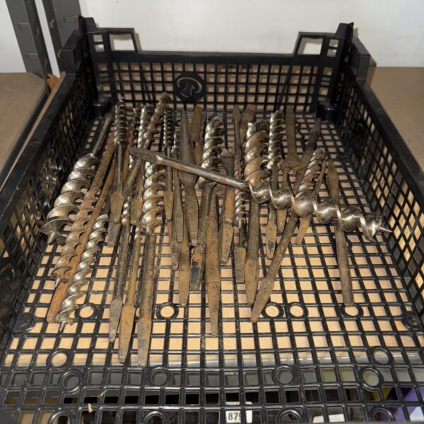 Tray of vintage metal drill bits for metalworking.
