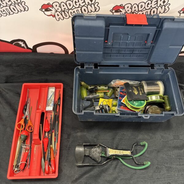 Vintage fishing tackle box with lures and a slingshot inside.