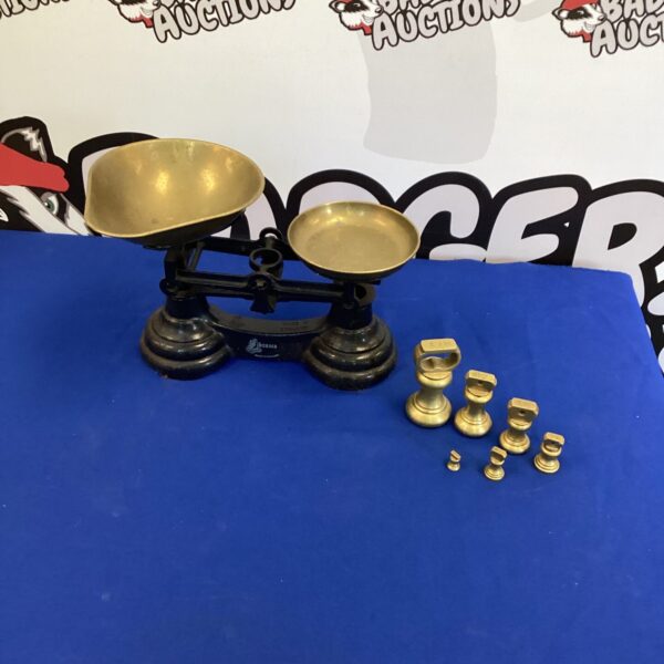 Antique Librasco balance scales with brass weights for accurate measurement.