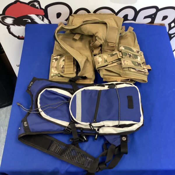 Tactical assault vest with MOLLE webbing and hydration pack.
