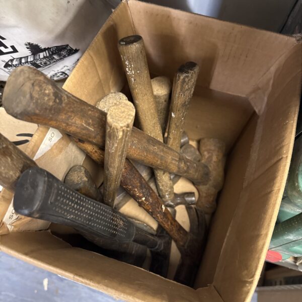 Vintage assorted hammers in a tool lot, showing signs of wear.