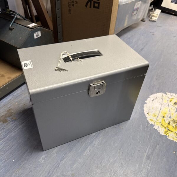 Vintage metal documents box with key for secure storage.