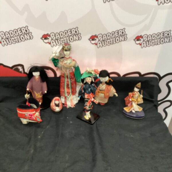 Vintage Japanese dolls in traditional costumes, a collectible display.