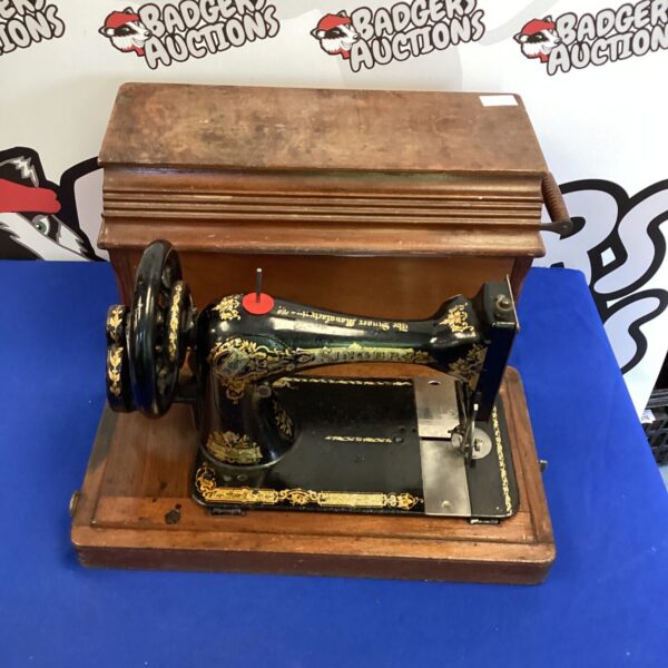 Antique sewing machine in original box, vintage collectible.
