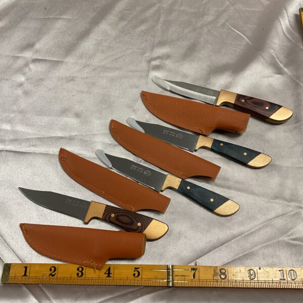 Lot of four vintage sheath knives with wooden handles.