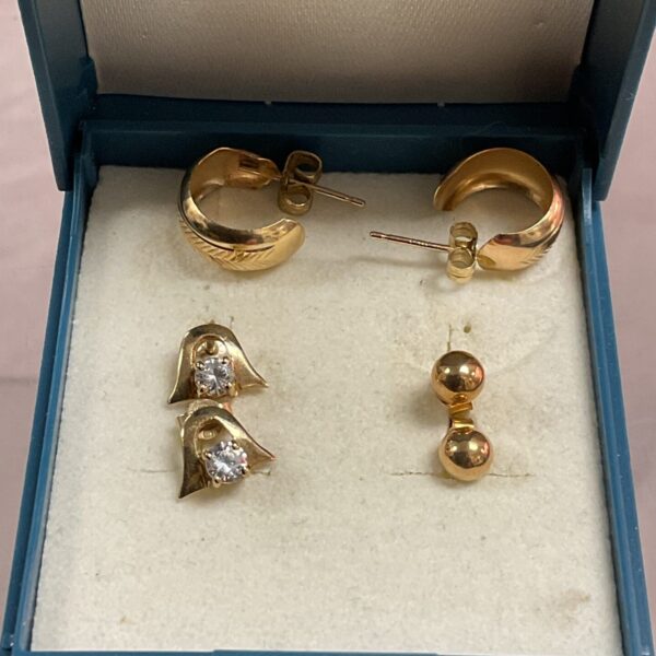 Three pairs of 9ct gold stud earrings presented as a lot.