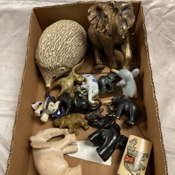 Vintage collection of ceramic, brass, and wooden elephant figurines.