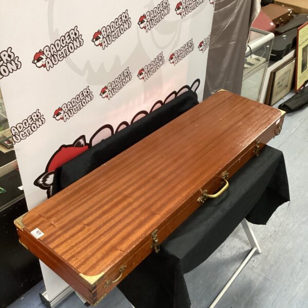 Antique wooden gun case with lined interior and folding legs.