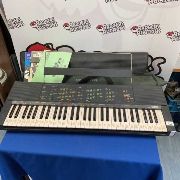 Vintage Yamaha PSR-70 keyboard with carrying bag.