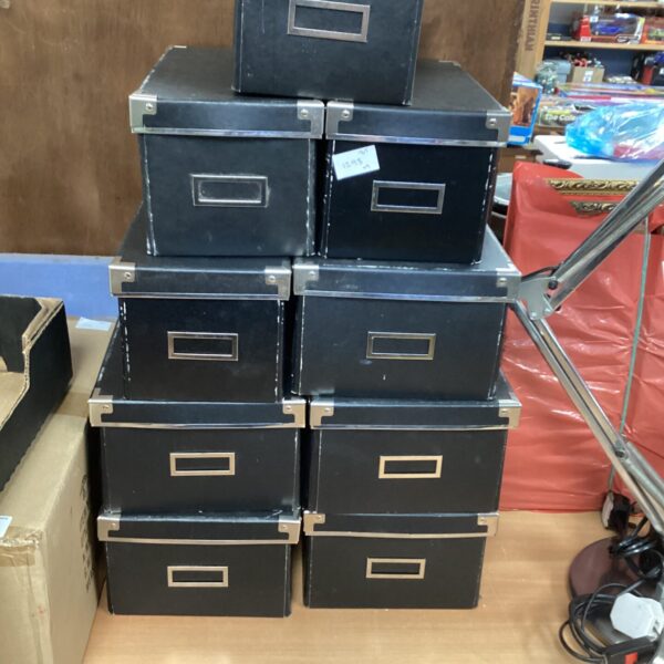 Lot of four vintage black storage boxes.