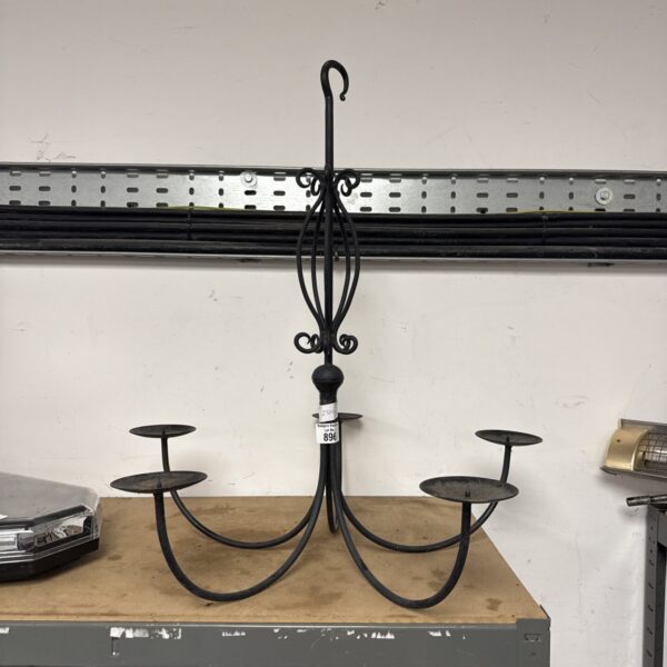Vintage wrought iron chandelier with multiple candle arms.