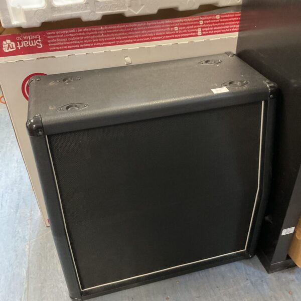 Black speaker cabinet with four speaker openings.