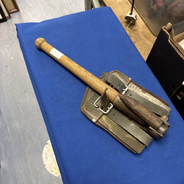 Vintage folding spade with wooden handle and metal digging head.