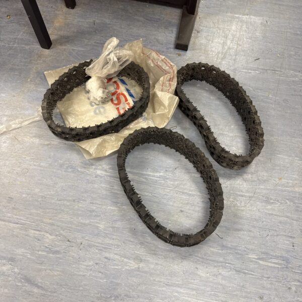 Lot of three golf cart replacement treads showing wear.
