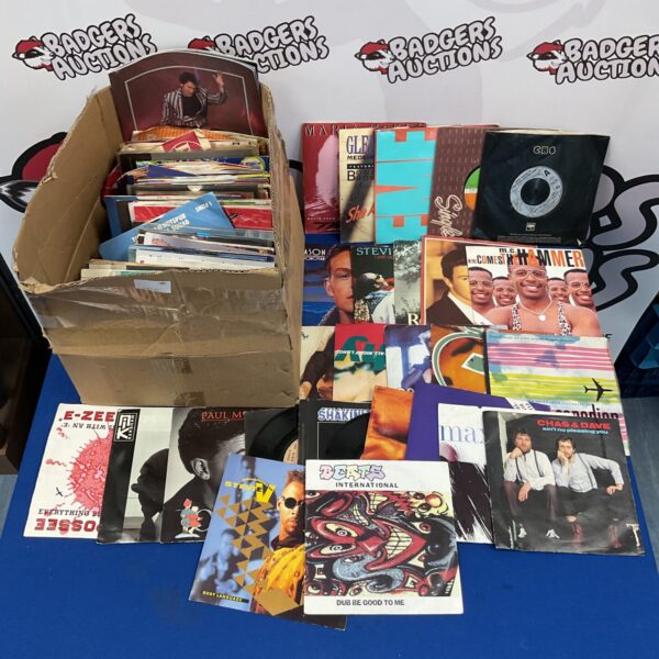 Box of vintage 7 inch vinyl records for collectors.