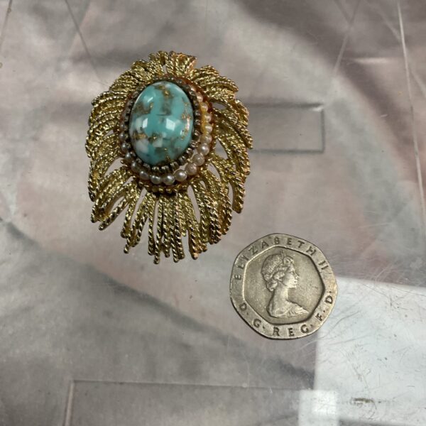Vintage 1950s floral brooch with turquoise cabochon and pearl accents.