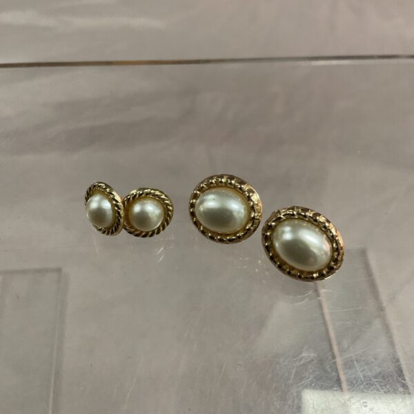 Pair of 9ct gold stud earrings on a neutral background.