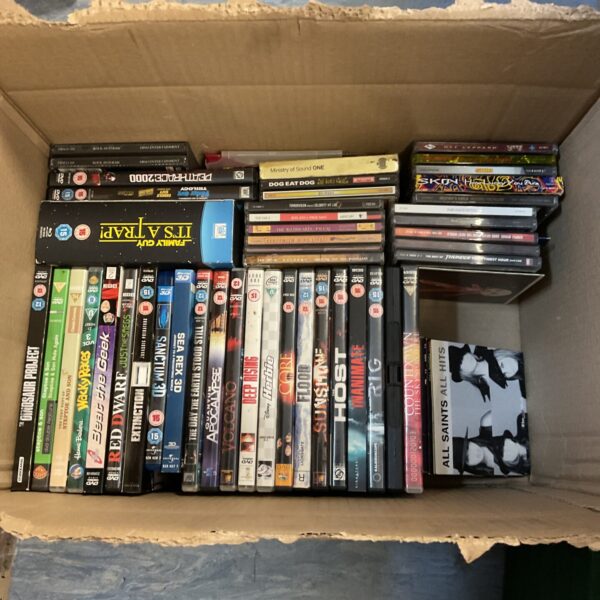 Mixed lot of DVDs, Blu-rays, and CDs for entertainment.