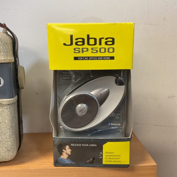 Jabra SP500 wireless speakerphone in box, Bluetooth hands-free device.