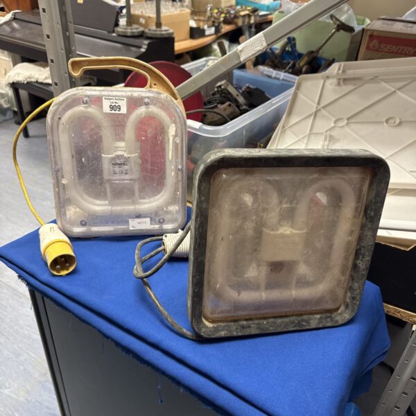 Vintage 110v site light with metal cage and carry handle.