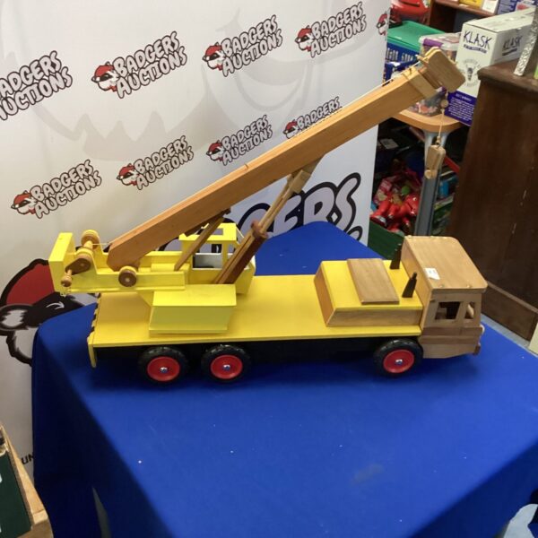 Large yellow wooden toy crane for vintage collectors.