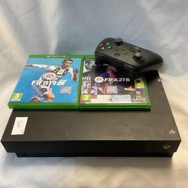 Microsoft Xbox One X console with controller and games displayed.