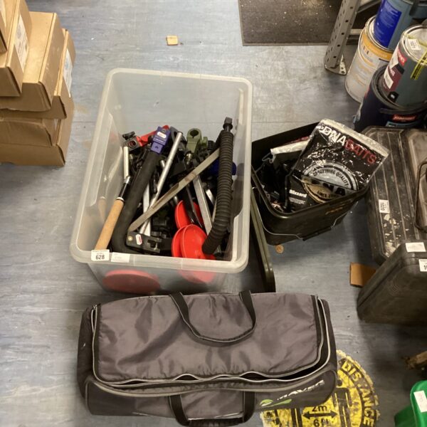 Assorted fishing tackle and equipment in a plastic container.