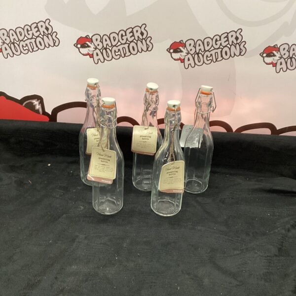 Lot of five vintage preserving bottles for kitchen storage.