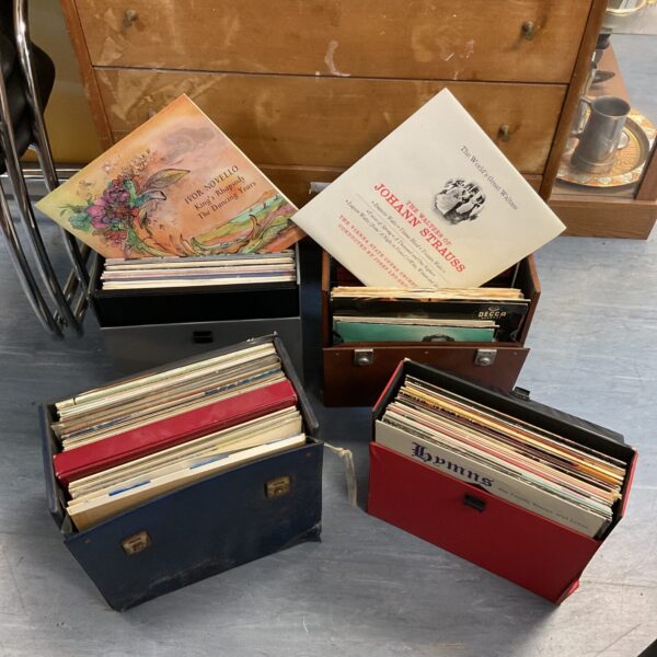 Vintage vinyl record cases filled with a large collection of 12” records.