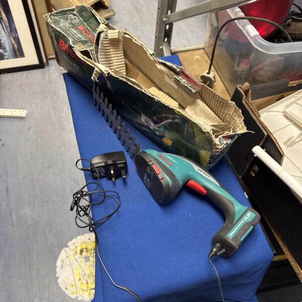 Bosch cordless hedge trimmer with charger, used condition.