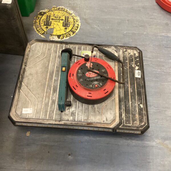 Manual tile cutter with coiled extension lead for DIY projects.