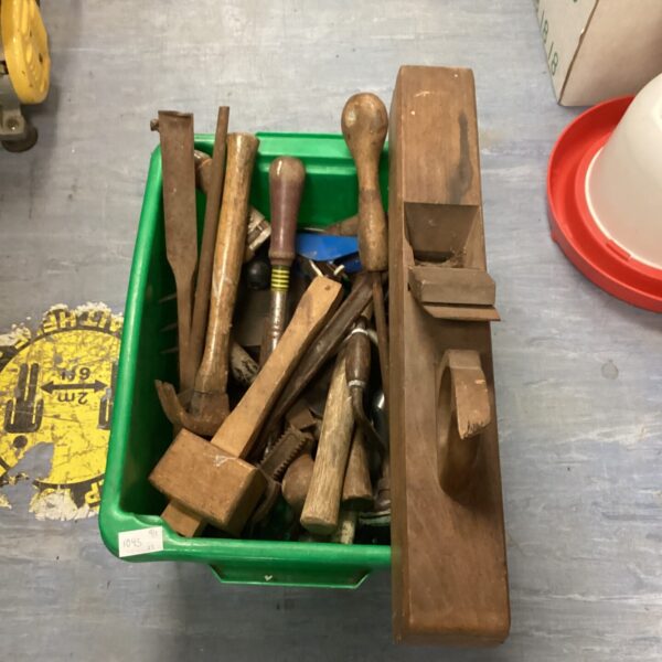 Vintage tool lot with various hand tools in a green container.