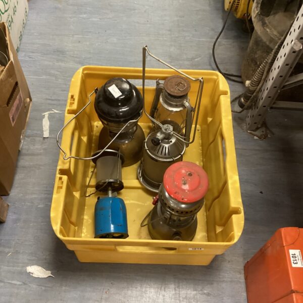 Selection of vintage camping lamps in a yellow container.