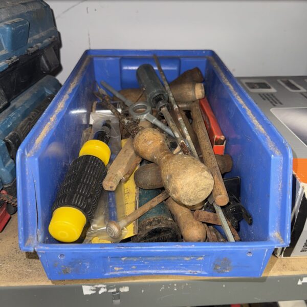Assorted vintage hand tools in a blue tray, workshop collection.