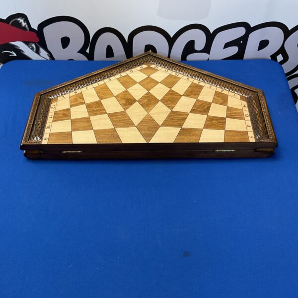 Closed vintage three-player chess set with hexagonal wooden board.