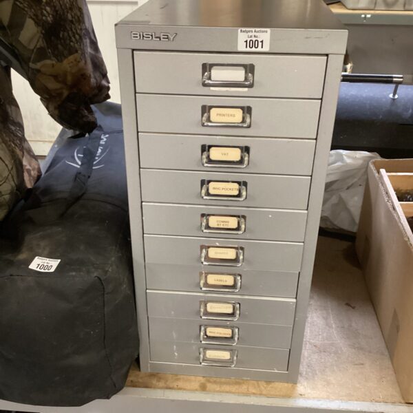 Metal Bisley filing cabinet with multiple drawers for office storage.