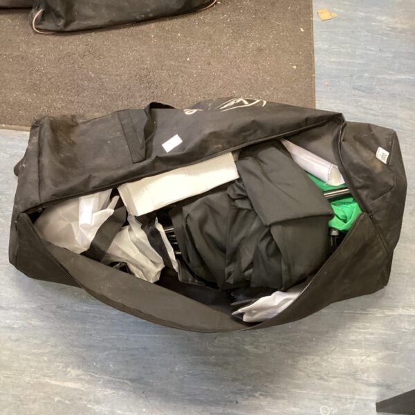 Closed photography backdrop kit carry bag with visible wear.