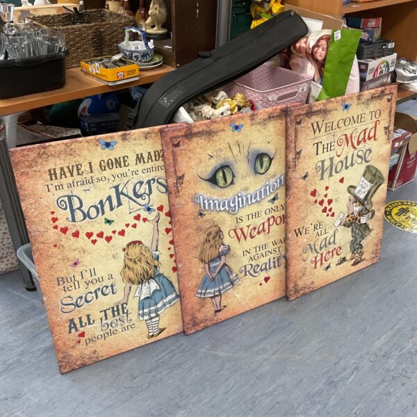 Group of three Alice in Wonderland canvas prints with vintage style.