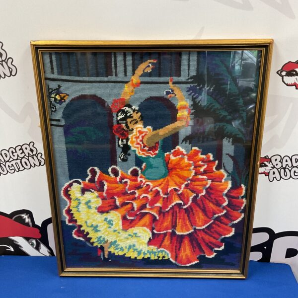 Vintage embroidery of a Spanish dancer in a gilt frame.