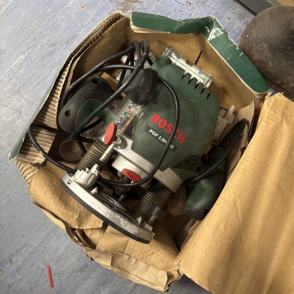Used Bosch Pof 1200 AE router in a cardboard box.