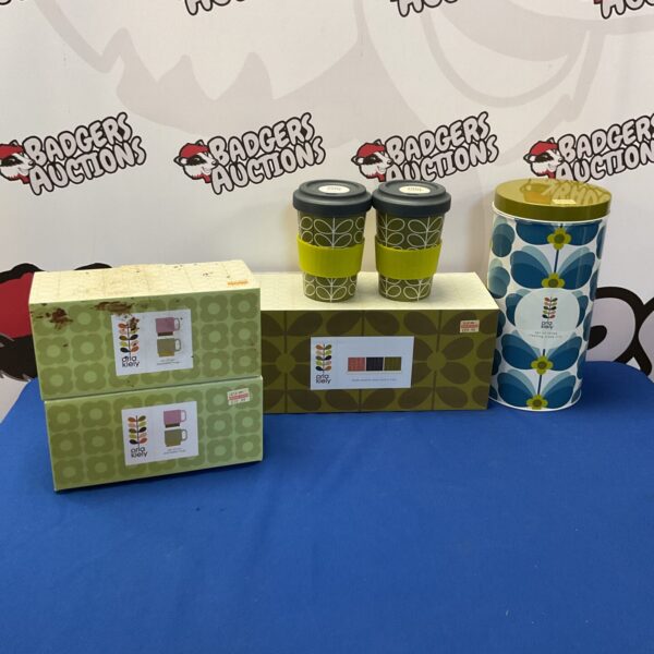 Orla Kiely collection featuring mugs, plant pots, and cake tins with patterned designs.