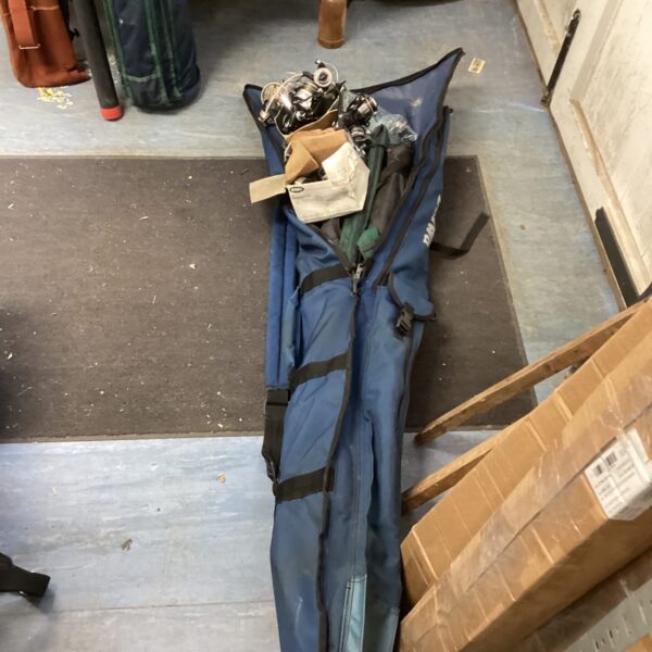 Daiwa fishing bag filled with rods, reels, and angling tackle.