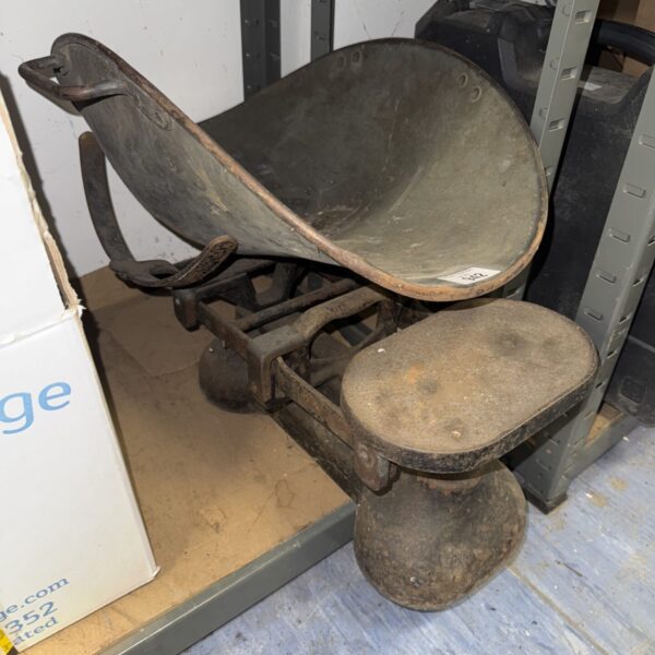 Large vintage balance scales with cast iron pans.
