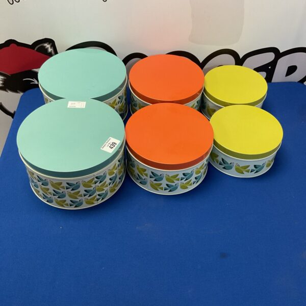 Colourful set of six Rex London nesting tins for kitchen storage.
